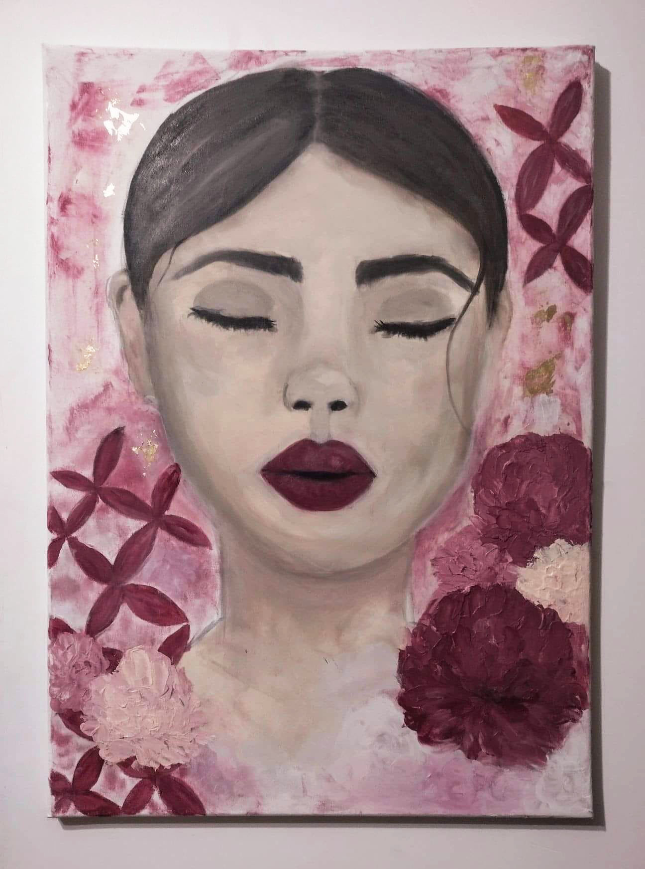 Acrylic painting of a woman's face among flowers